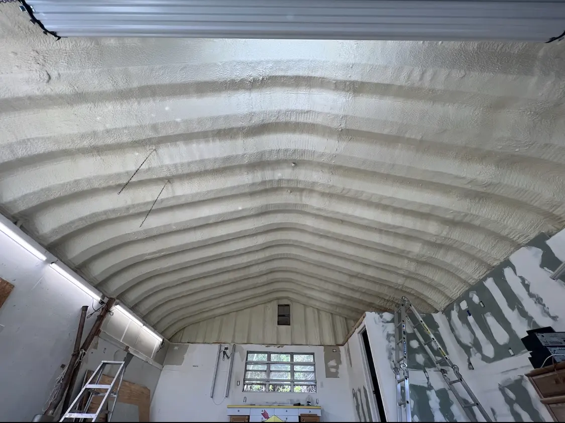Spray polyurethane foam applied to the underside of a metal roof deck in Westgate